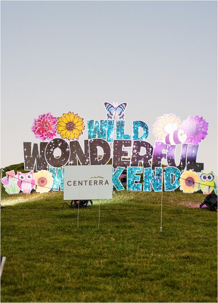A sign that says wild wonderful weekend in front of a grassy field in Northern Colorado.