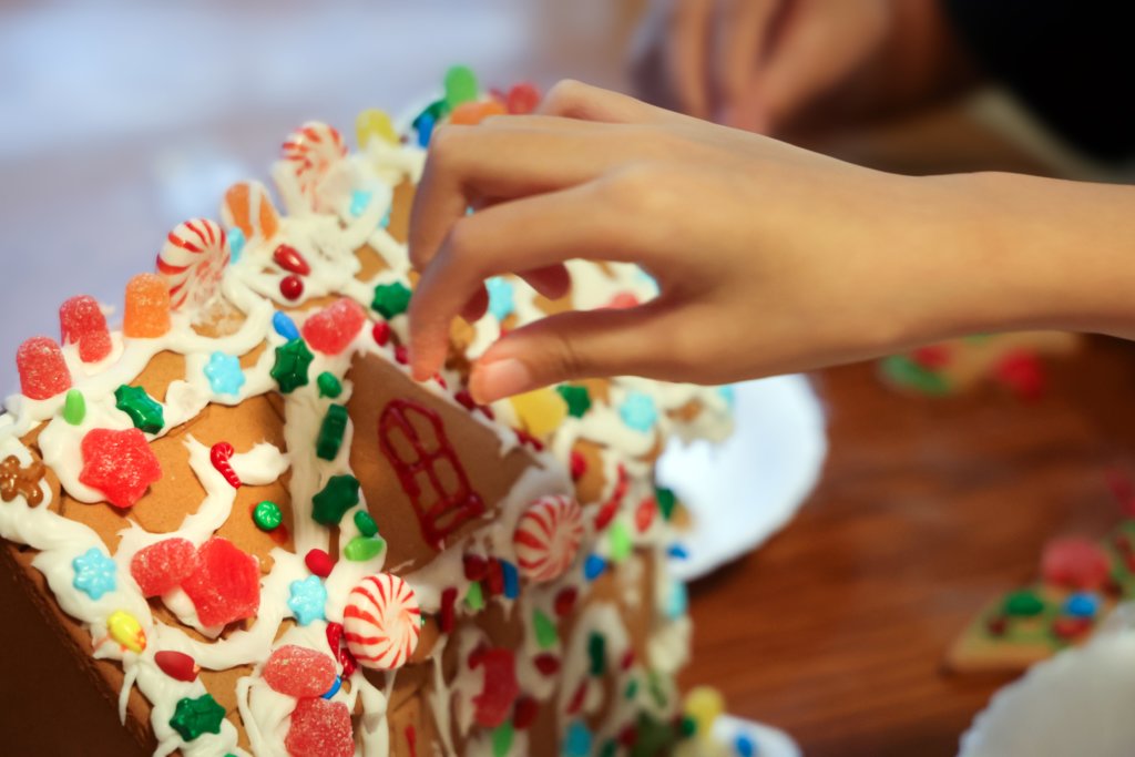 person making gingerbread house