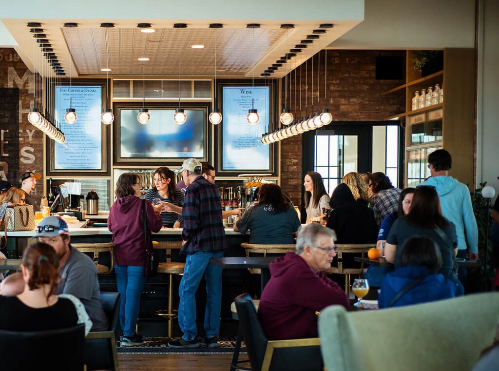 A group of people dining at tables in a restaurant.