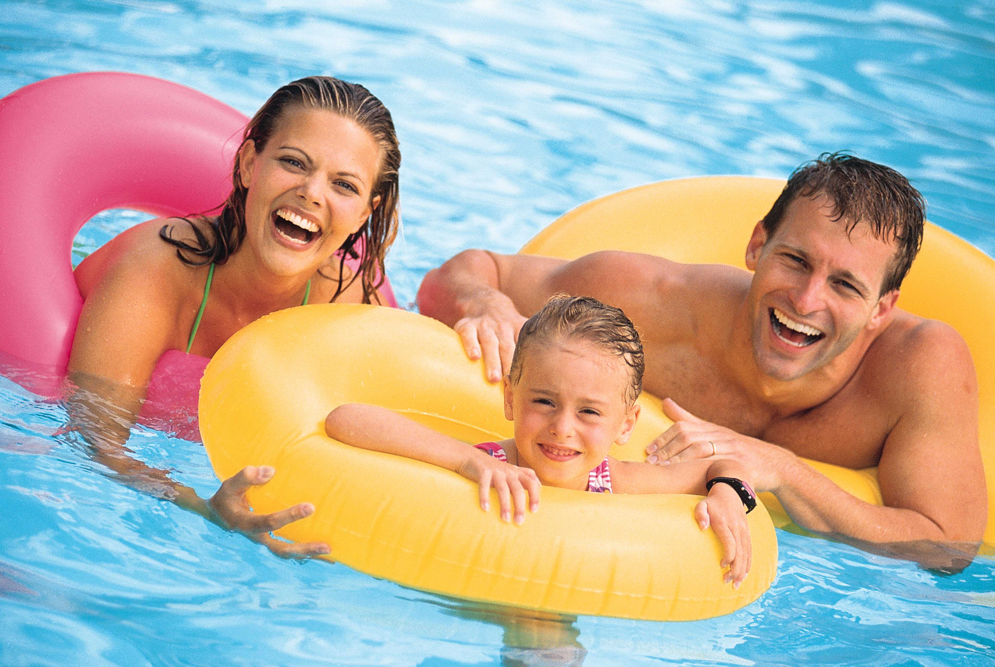 Family in pool with inner tubes