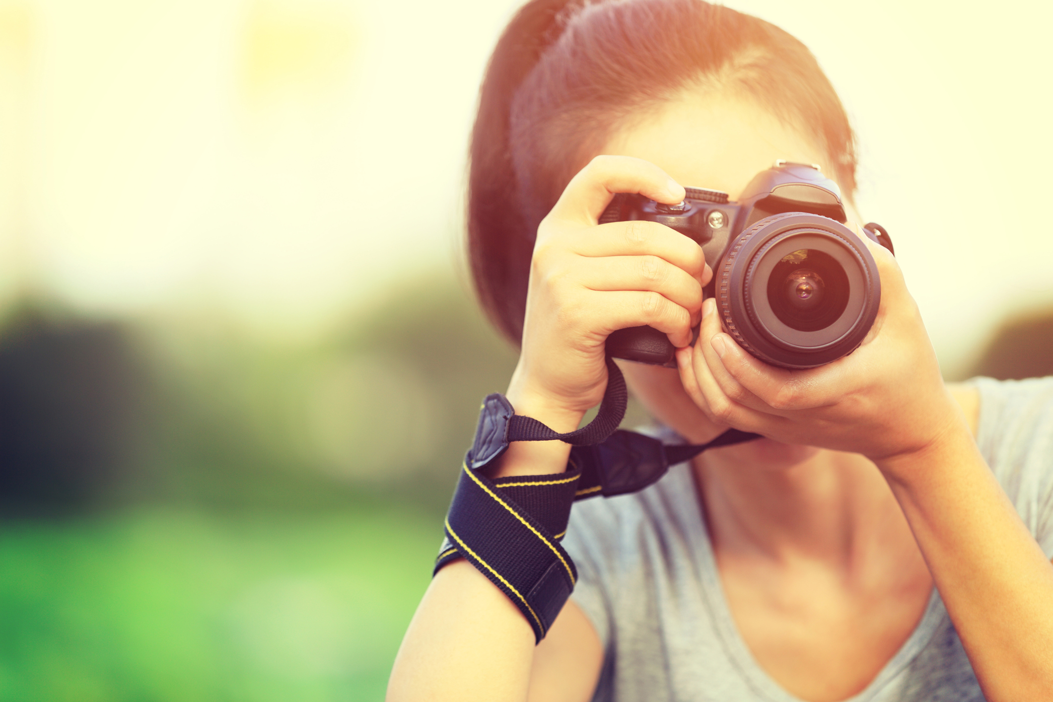 young woman photographer taking photo outdoor